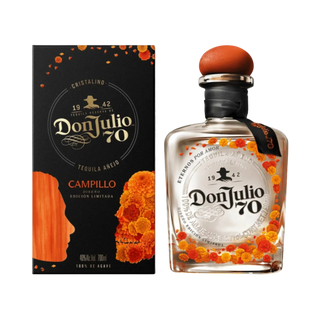 A bottle of Don Julio 70 Campillo tequila alongside its black packaging box, decorated with orange marigold illustrations and featuring a clear glass body showing the liquid inside.
